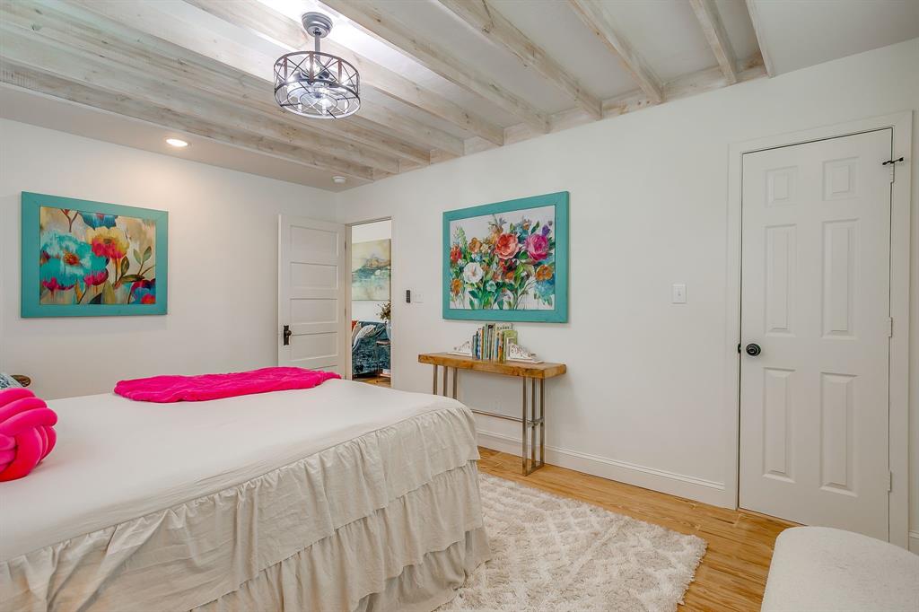 508 South Elm Street Weatherford, TX 76086 - Photo 24 of 40 a bedroom with furniture and a chandelier
