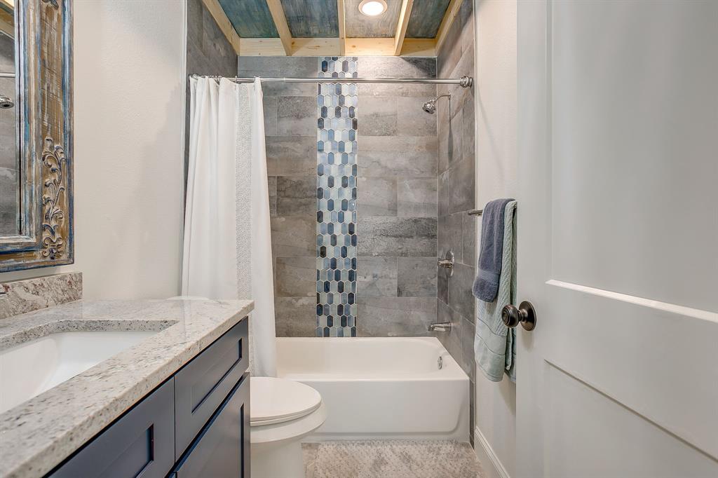508 South Elm Street Weatherford, TX 76086 - Photo 25 of 40 a bathroom with a granite countertop bathtub shower sink vanity and toilet