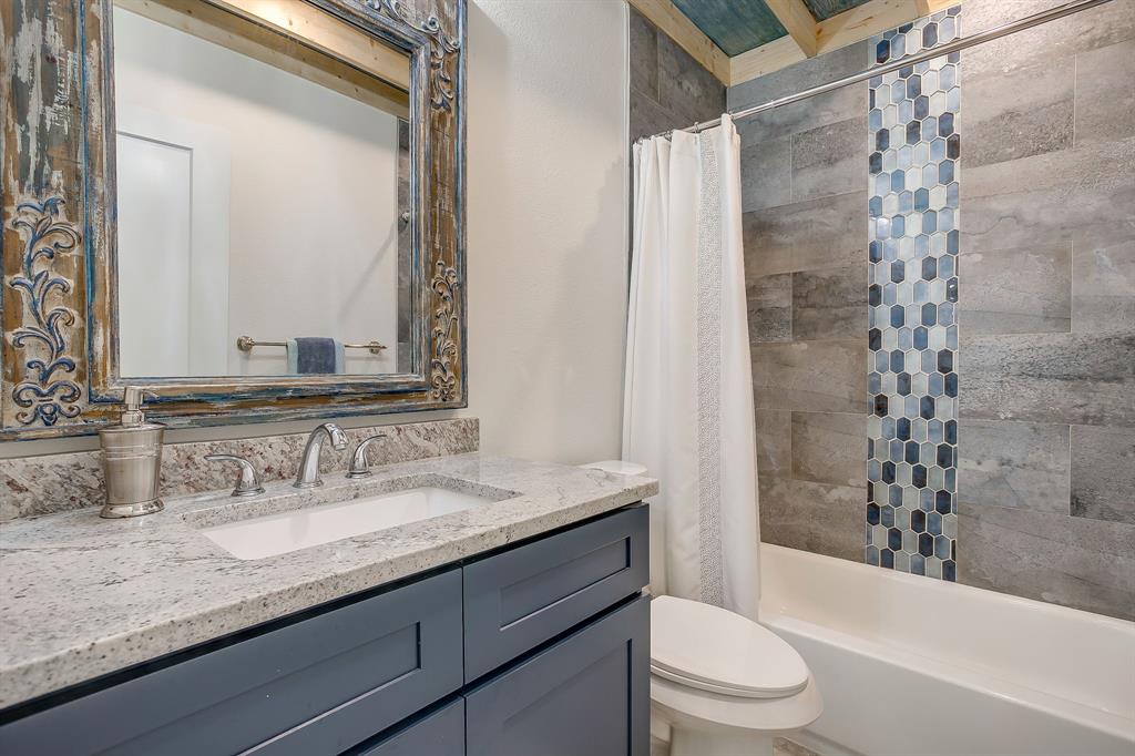 508 South Elm Street Weatherford, TX 76086 - Photo 26 of 40 a bathroom with a granite countertop sink toilet mirror and shower
