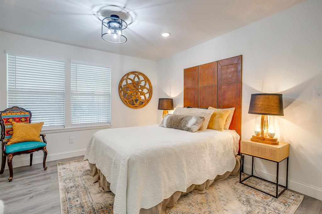508 South Elm Street Weatherford, TX 76086 - Photo 27 of 40 a bedroom with a bed and a lamp on dresser