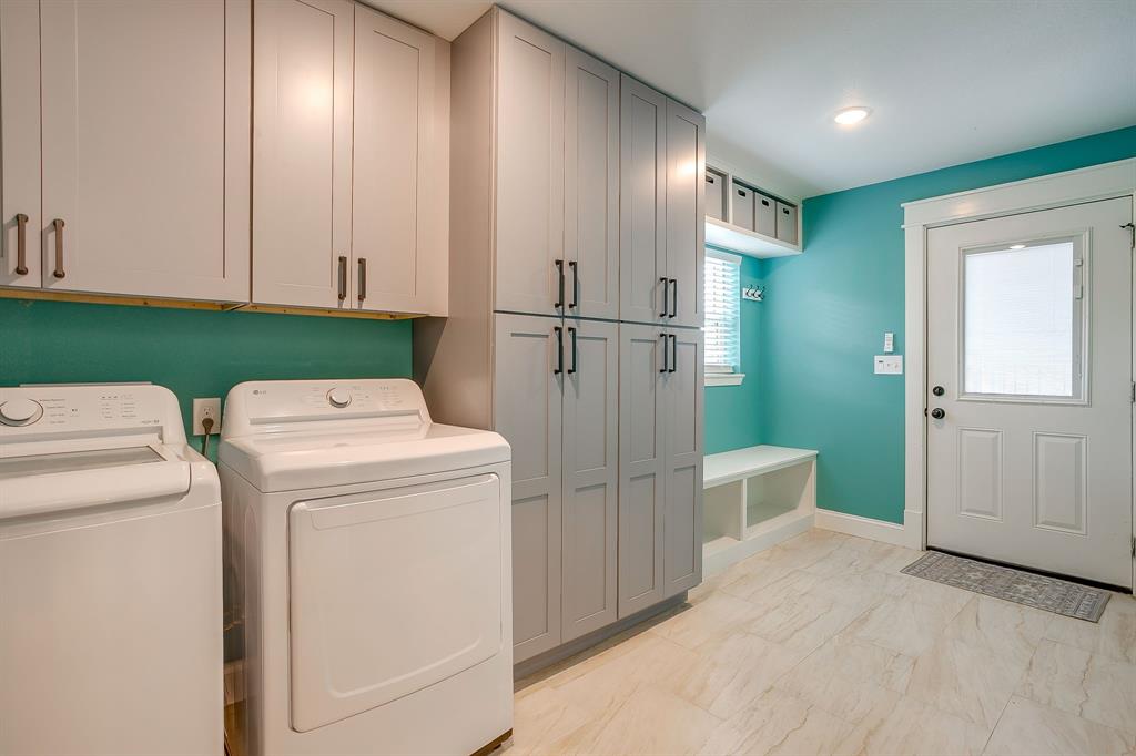 508 South Elm Street Weatherford, TX 76086 - Photo 30 of 40 a view of washer and dryer with kitchen in the background
