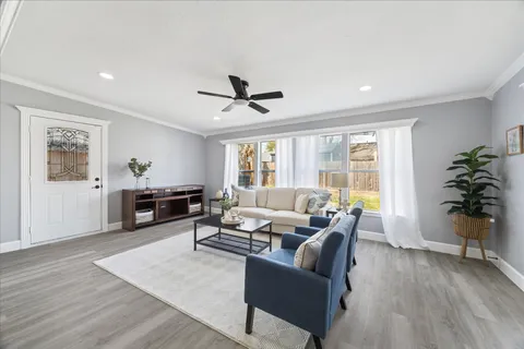 a living room with furniture and wooden floor