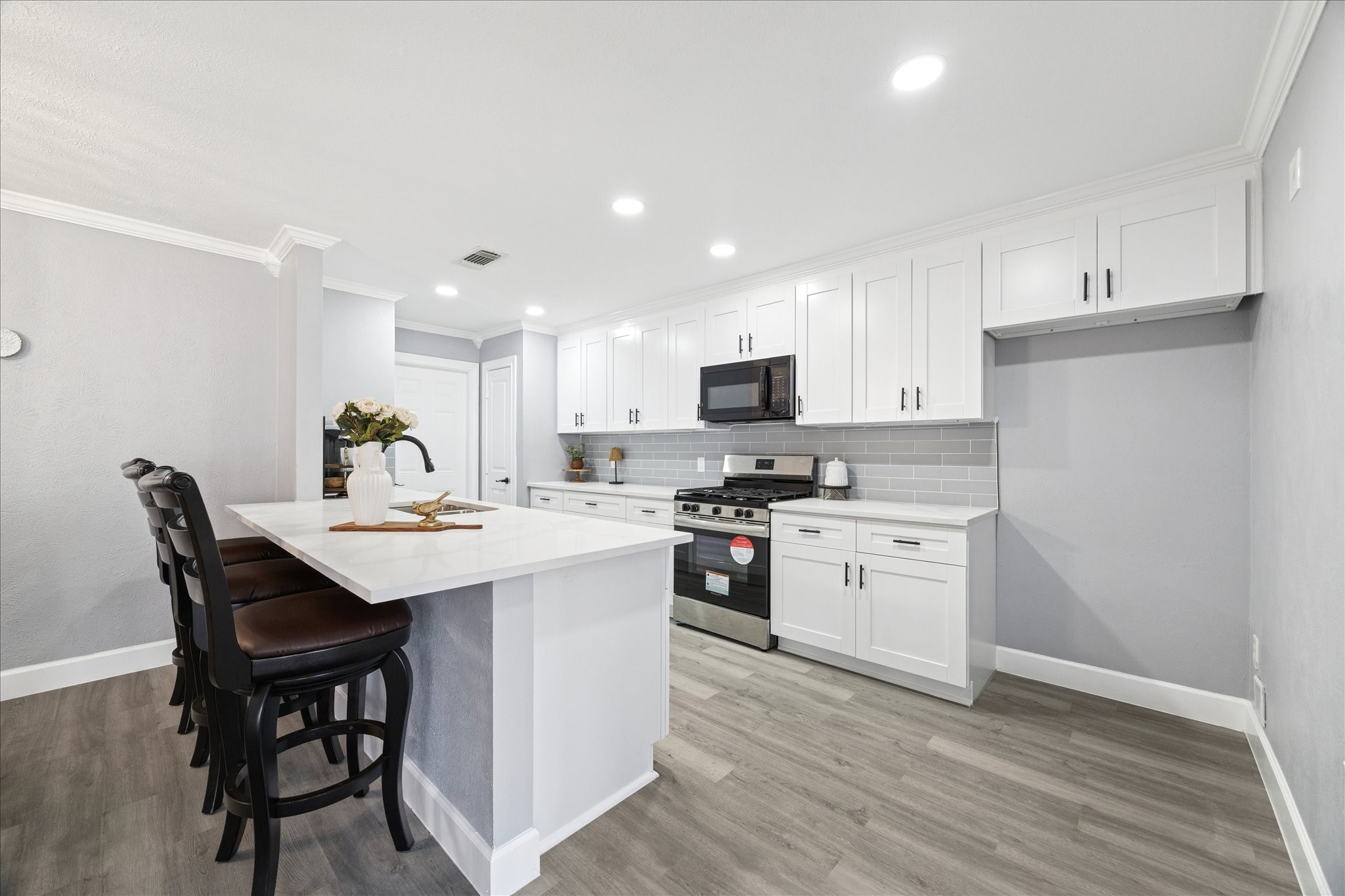 143 Mill Stream Lane Houston, TX 77060 - Photo 12 of 20 a kitchen with a sink white cabinets and stainless steel appliances