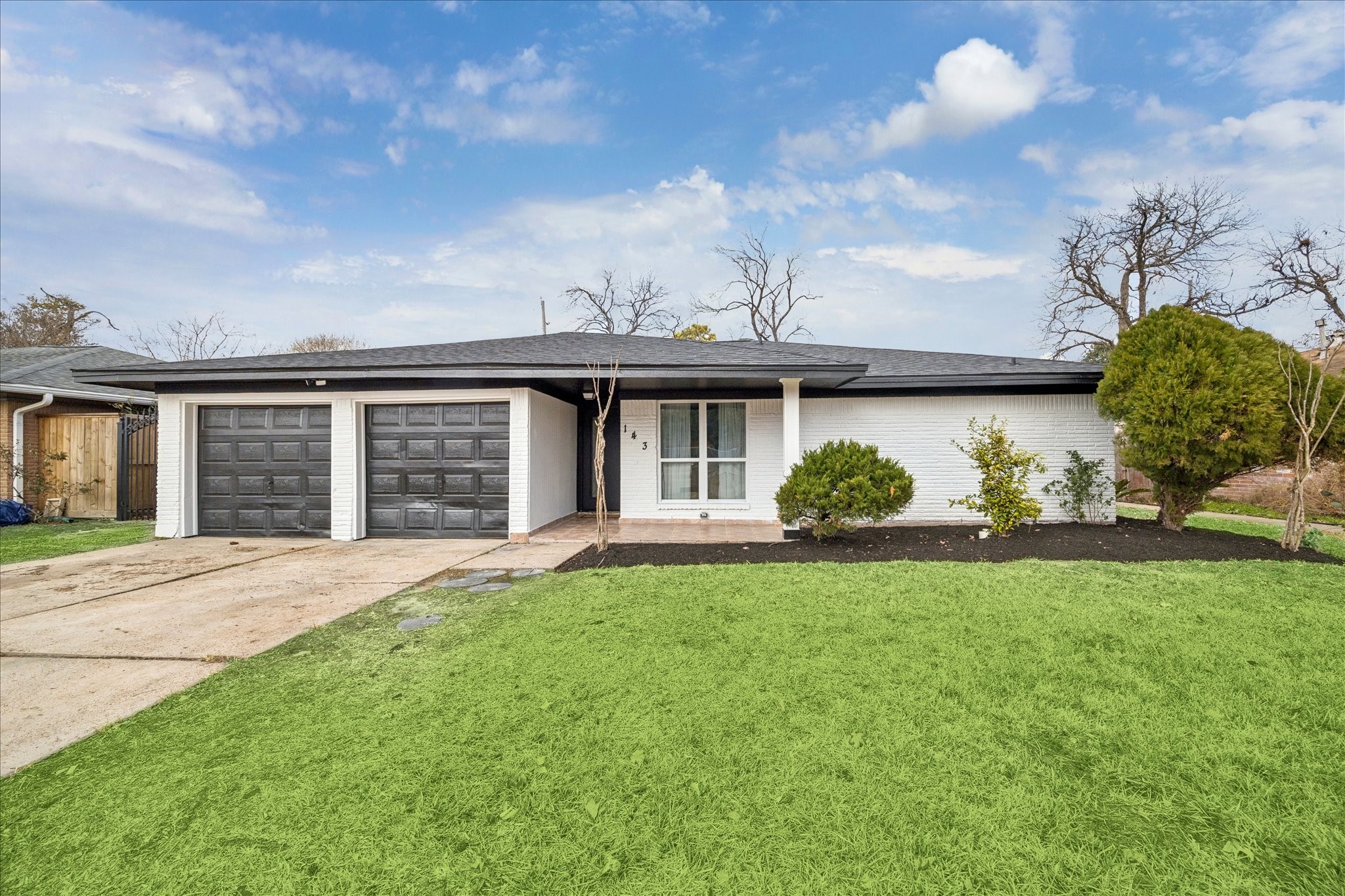 143 Mill Stream Lane Houston, TX 77060 - Photo 2 of 20 a front view of a house with a garden and plants