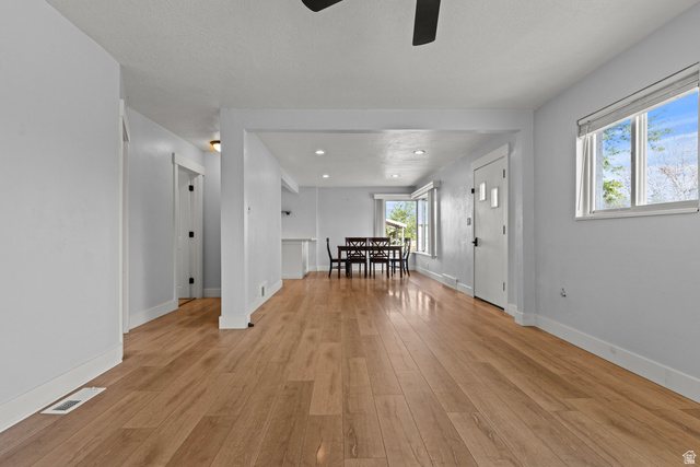 2101 West 3900th Street South Roy, UT 84067 - Photo 10 of 36 Open-concept living space featuring wood-finish flooring, recessed lighting, and a neutral color palette