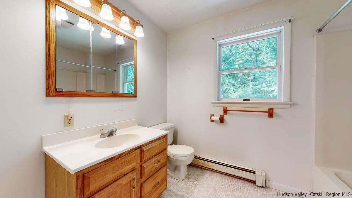 520 Plutarch Road New Paltz, NY 12561 - Photo 18 of 28 a bathroom with a sink toilet and window