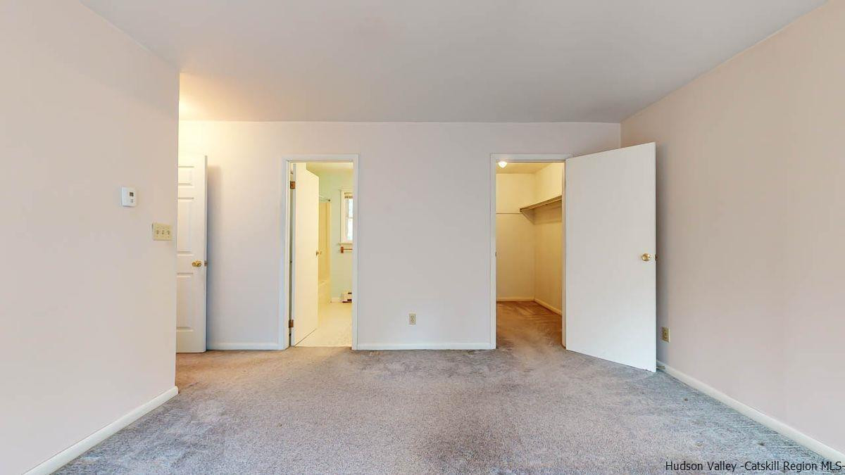 520 Plutarch Road New Paltz, NY 12561 - Photo 19 of 28 an empty room with windows and bathroom