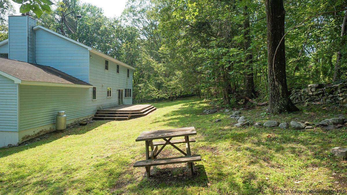 520 Plutarch Road New Paltz, NY 12561 - Photo 26 of 28 a view of a swimming pool with a bench and trees