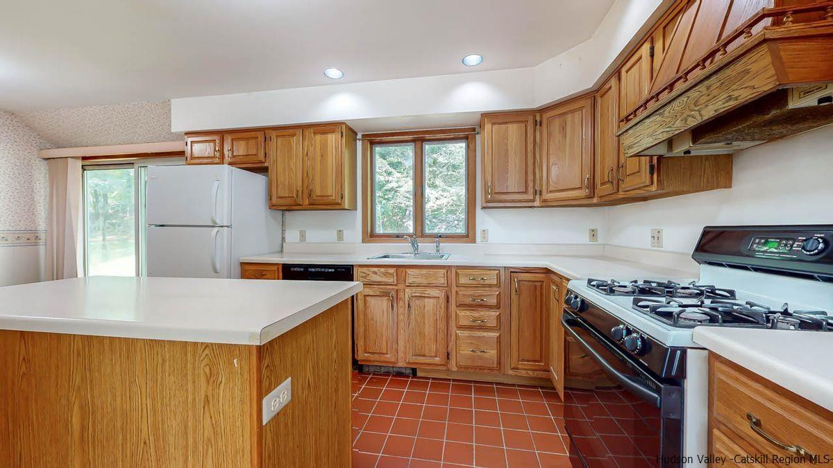 520 Plutarch Road New Paltz, NY 12561 - Photo 3 of 28 a kitchen with stainless steel appliances a stove sink microwave and cabinets