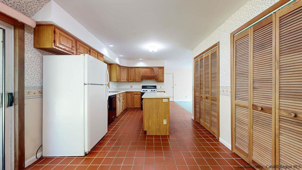 520 Plutarch Road New Paltz, NY 12561 - Photo 4 of 28 a kitchen with stainless steel appliances granite countertop a refrigerator a stove and a sink with wooden floor