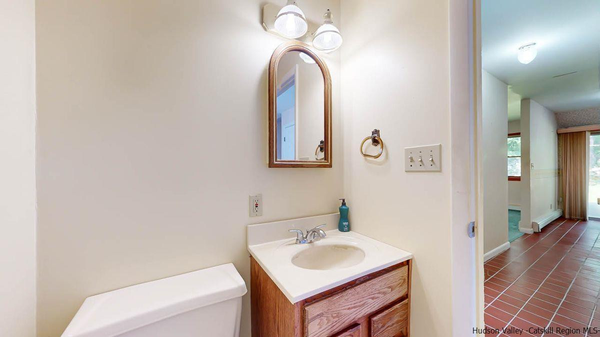 520 Plutarch Road New Paltz, NY 12561 - Photo 9 of 28 a bathroom with a toilet sink and mirror