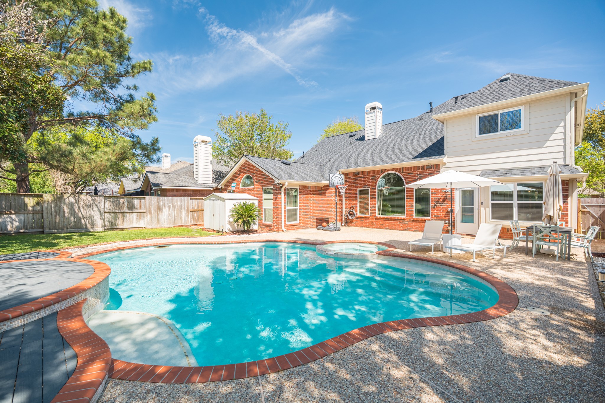 a view of a house with swimming pool and sitting area