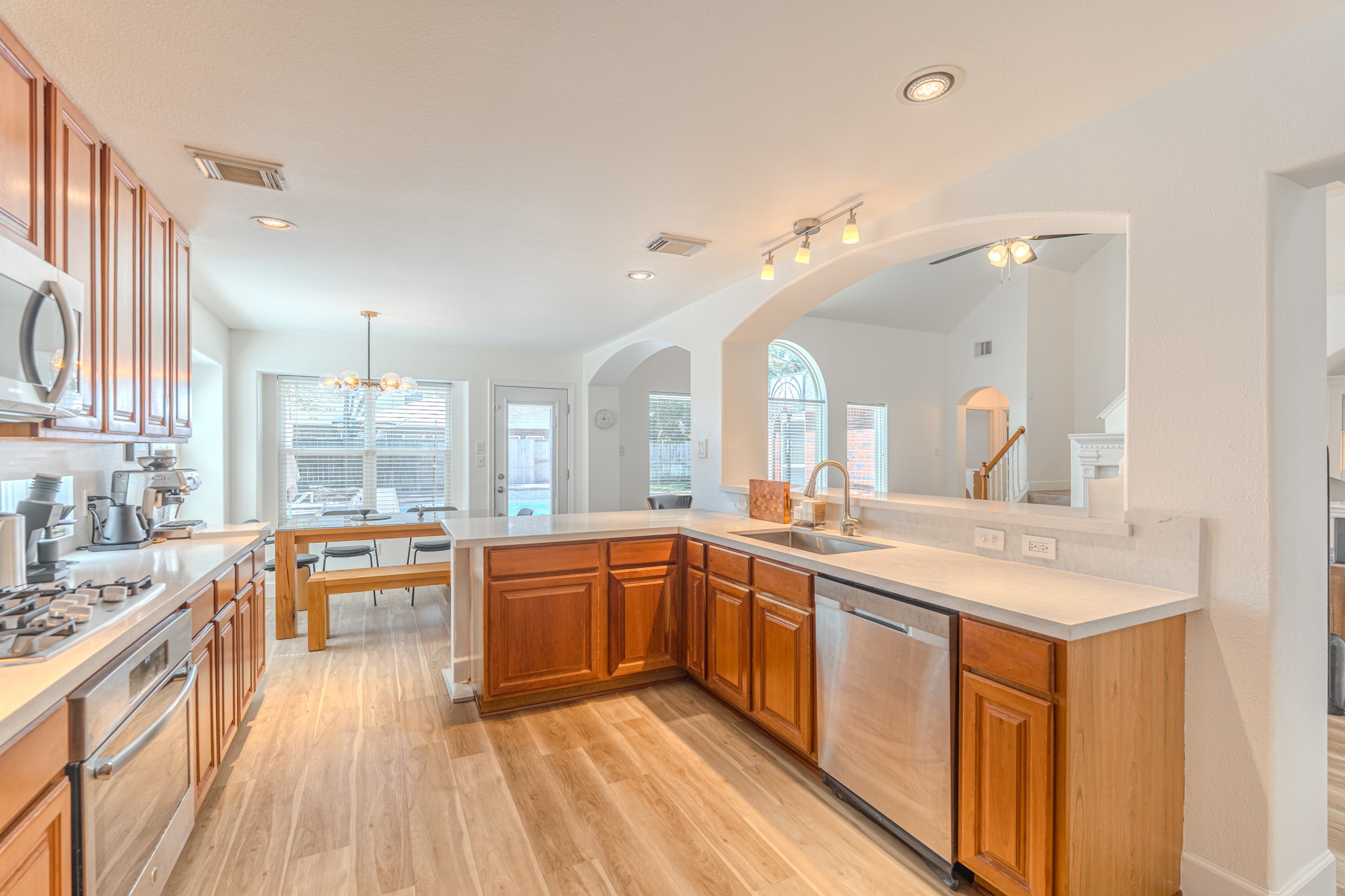 1107 Compass Cove Circle Spring, TX 77379 - Photo 17 of 42 a large kitchen with a lot of counter space and a wooden floor
