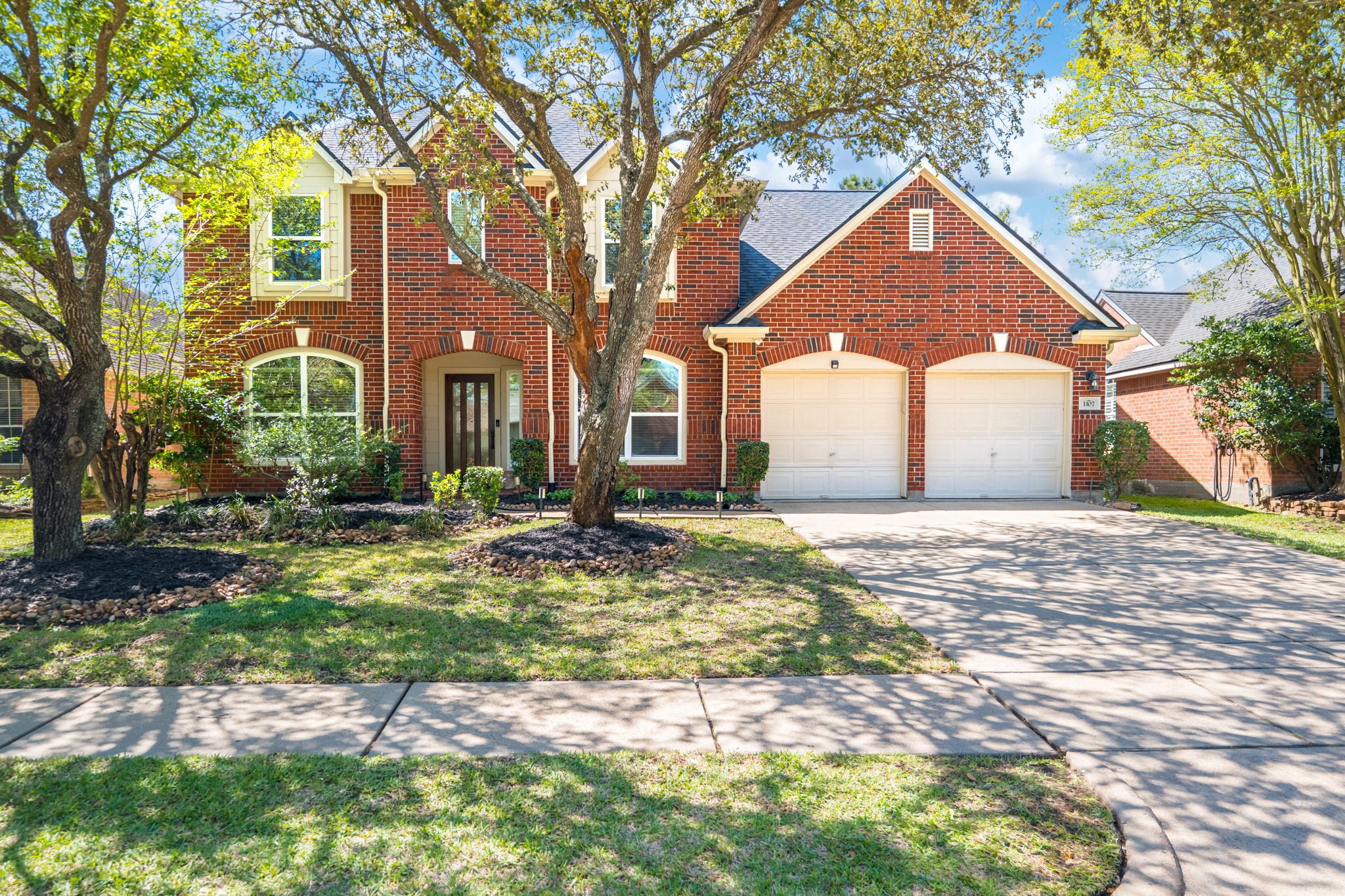 1107 Compass Cove Circle Spring, TX 77379 - Photo 2 of 42 a front view of a house with garden