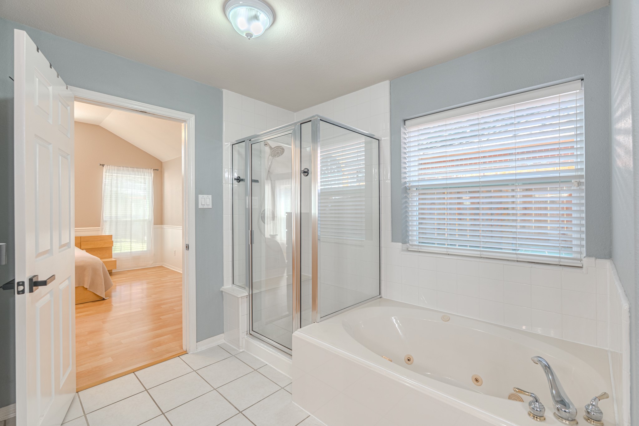 1107 Compass Cove Circle Spring, TX 77379 - Photo 25 of 42 a bathroom with a bathtub and a shower