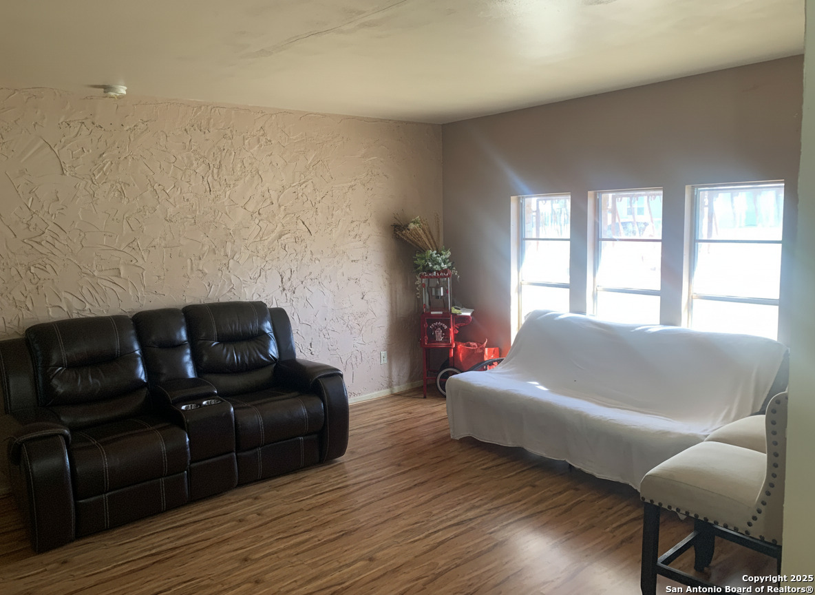 127 Roesler Road San Antonio, TX 78220 - Photo 4 of 17 a living room with couches and a couch next to a window