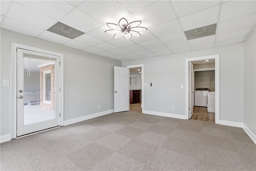 501 Capri Point Lavonia, GA 30553 - Photo 4 of 50 This versatile room features carpet flooring and offers direct access to an outdoor area and a dedicated laundry space.