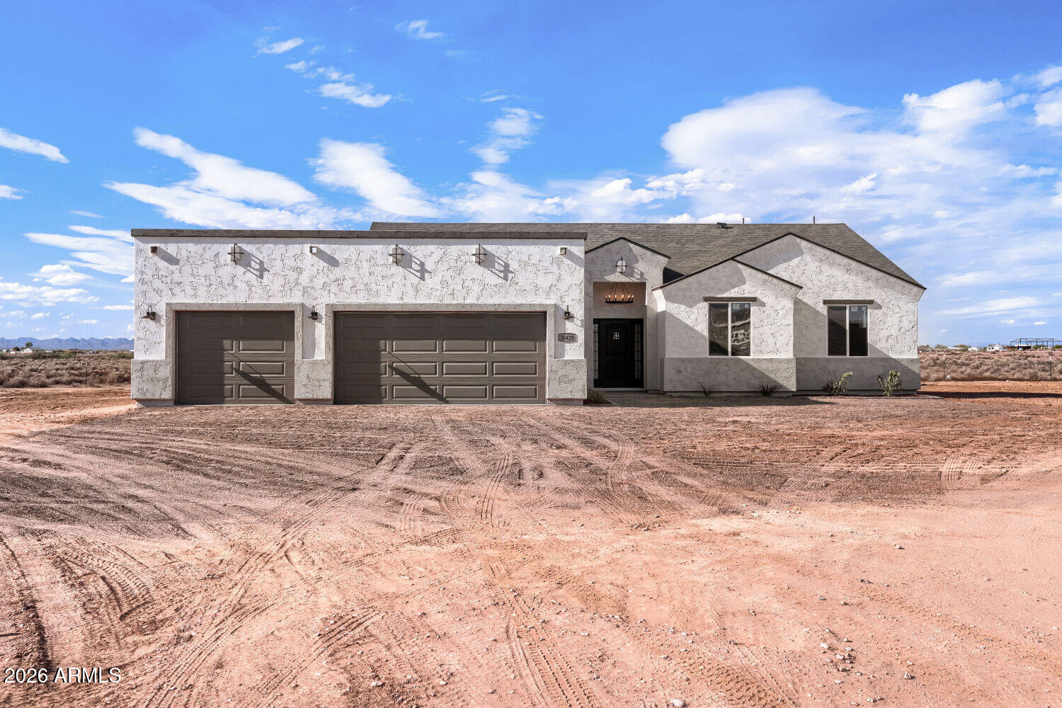 38420 West Buckeye Road Tonopah, AZ 85354 - Photo 2 of 28 a front view of a house with a yard and garage