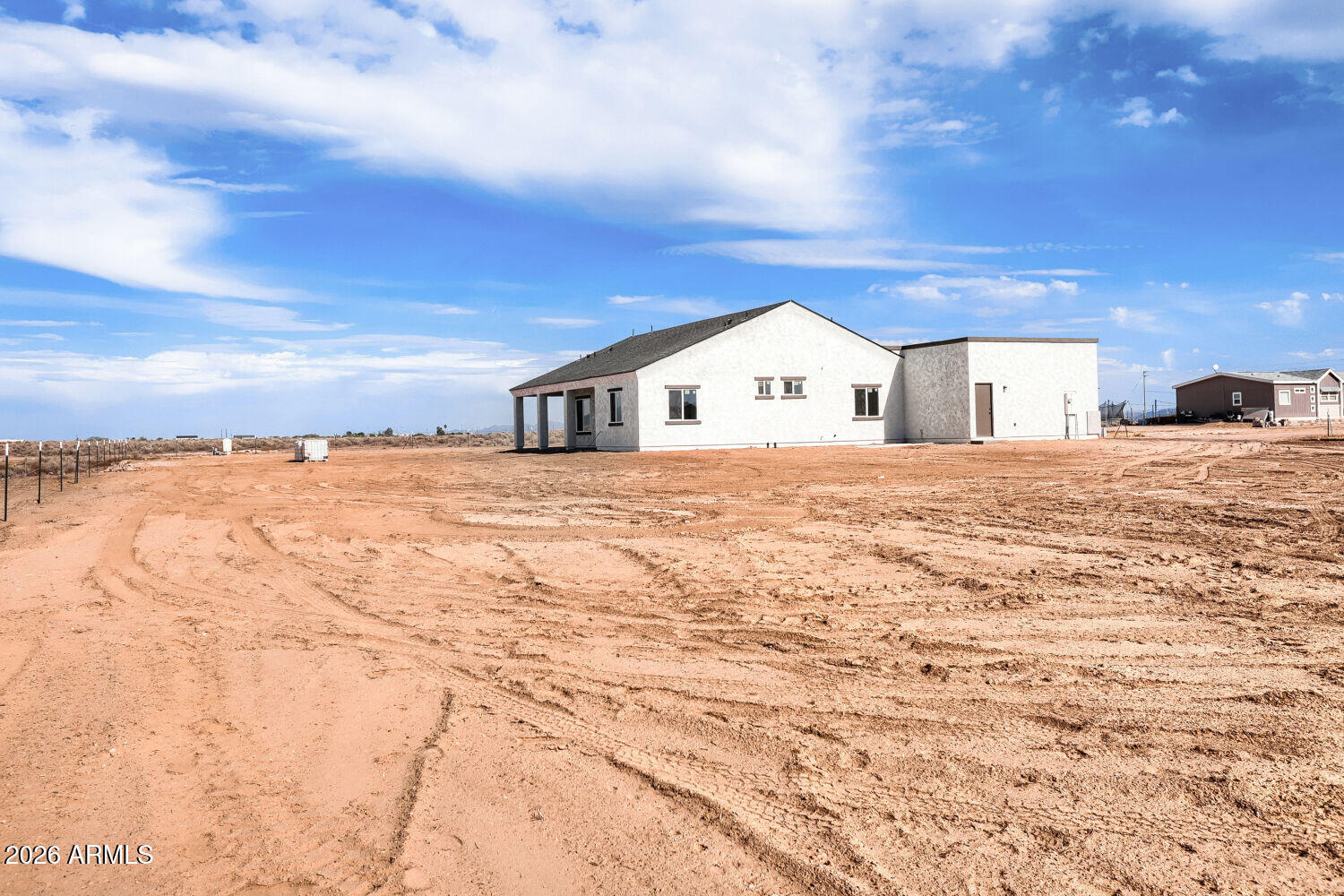38420 West Buckeye Road Tonopah, AZ 85354 - Photo 27 of 28 a view of a house with a yard and garage