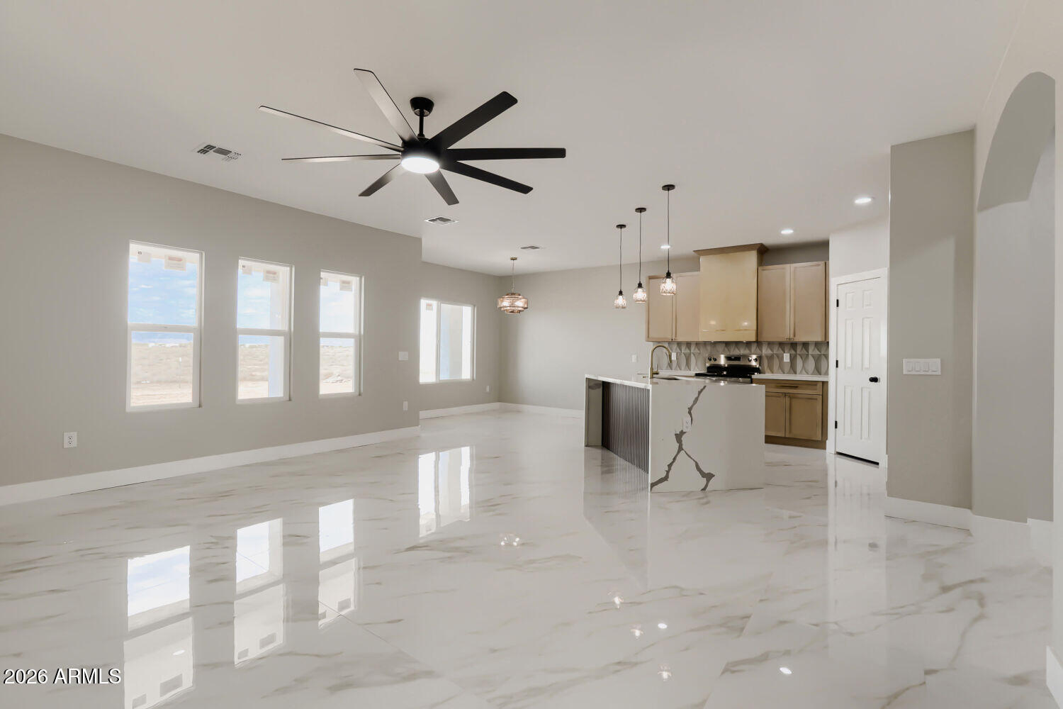 38420 West Buckeye Road Tonopah, AZ 85354 - Photo 5 of 28 a view of a kitchen with kitchen island a appliances wooden floor and a window