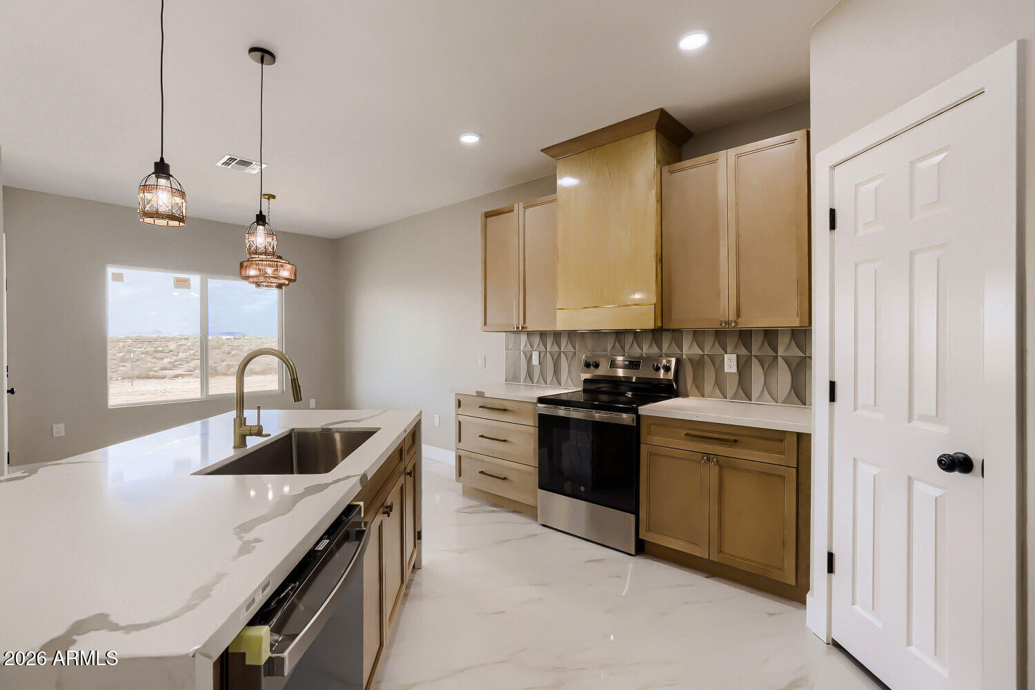 38420 West Buckeye Road Tonopah, AZ 85354 - Photo 9 of 28 a kitchen with stainless steel appliances granite countertop a sink a stove and a refrigerator