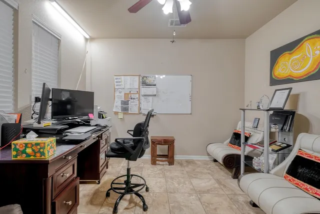 a work room with furniture and a flat screen tv