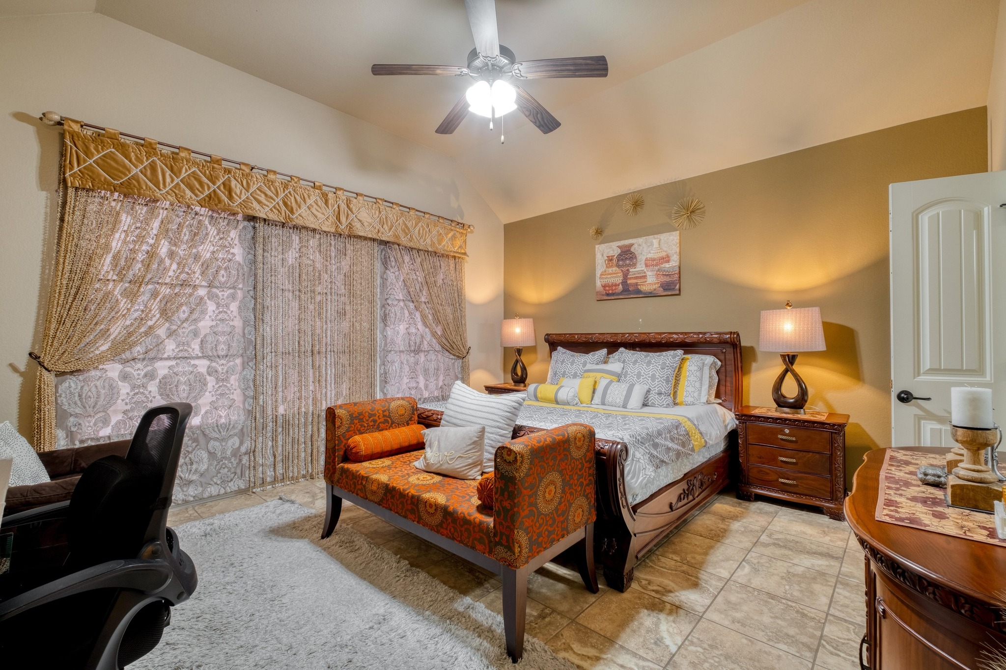 3040 Sachen Street Georgetown, TX 78626 - Photo 15 of 40 Bedroom featuring vaulted ceiling, light tile patterned floors, and ceiling fan