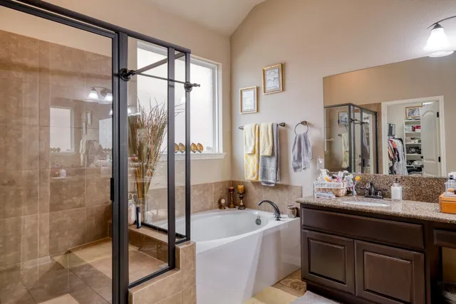 a bathroom with a bathtub sink and mirror