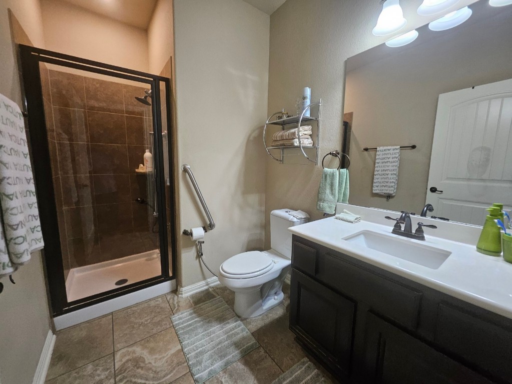 3040 Sachen Street Georgetown, TX 78626 - Photo 22 of 40 a bathroom with a sink a toilet a mirror and shower