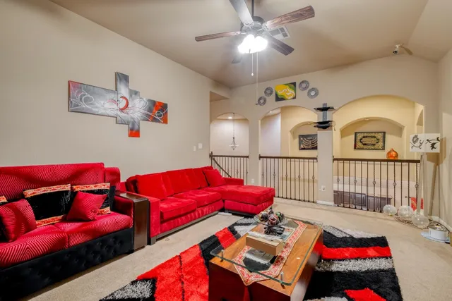 a living room with furniture and a baby crib
