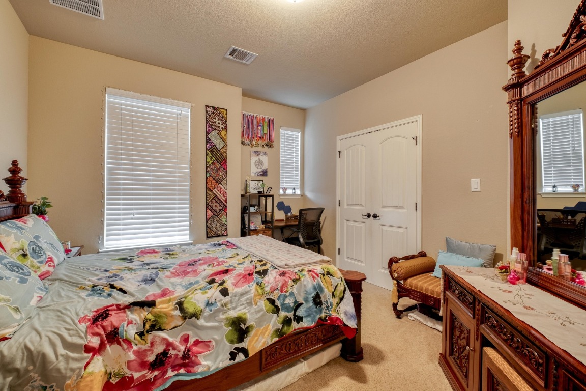 3040 Sachen Street Georgetown, TX 78626 - Photo 27 of 40 a bedroom that has a bed and a table in it