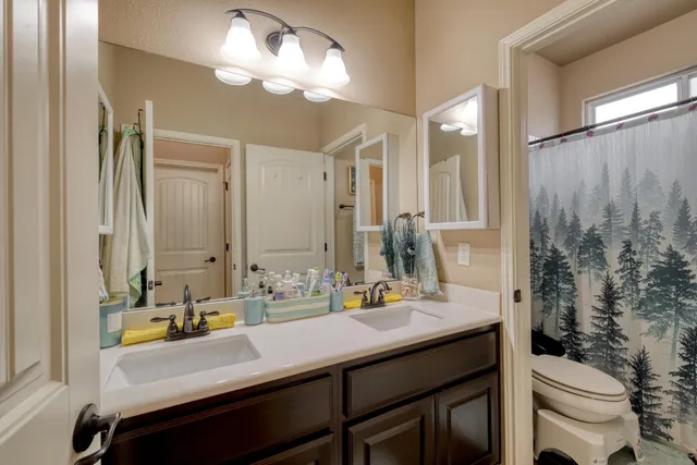 a bathroom with a sink double vanity and a mirror