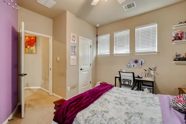 a bedroom with a bed and a table in it