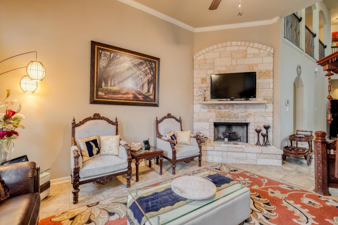 3040 Sachen Street Georgetown, TX 78626 - Photo 7 of 40 a living room with furniture a flat screen tv and a fireplace
