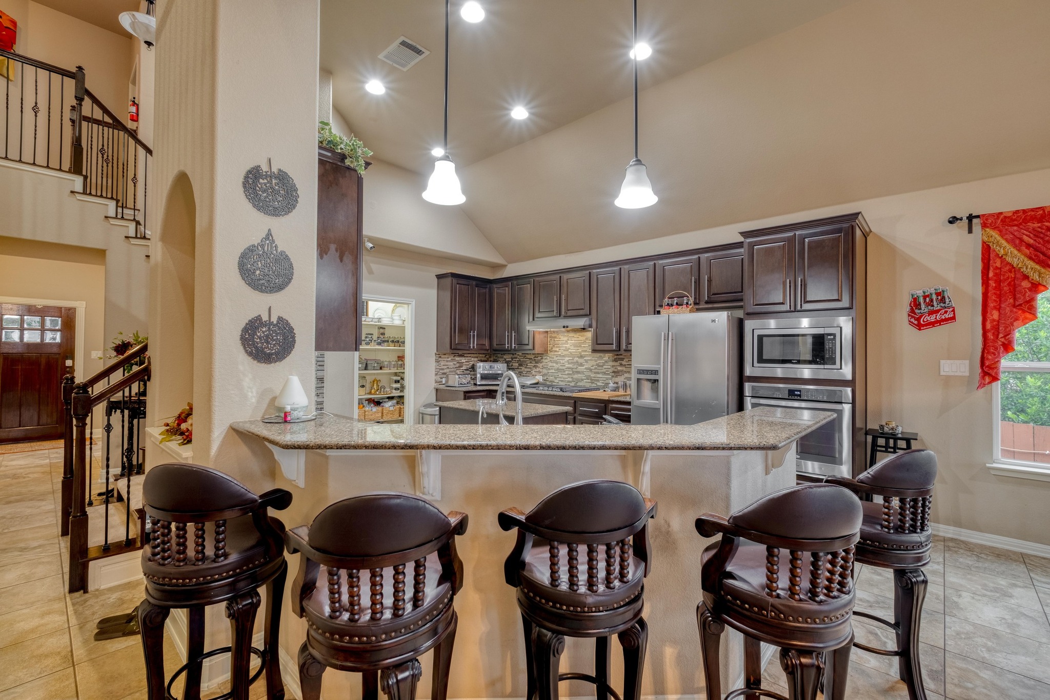 3040 Sachen Street Georgetown, TX 78626 - Photo 9 of 40 a kitchen with stainless steel appliances granite countertop a stove a sink dishwasher a dining table and chairs with wooden floor