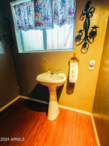 a bathroom with a sink mirror vanity and toilet