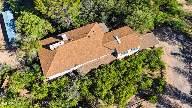 an aerial view of a house with a yard and garden