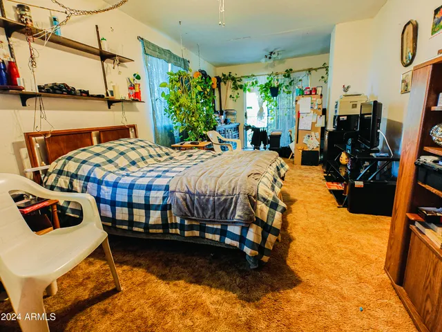a bathroom with a granite countertop toilet sink and mirror