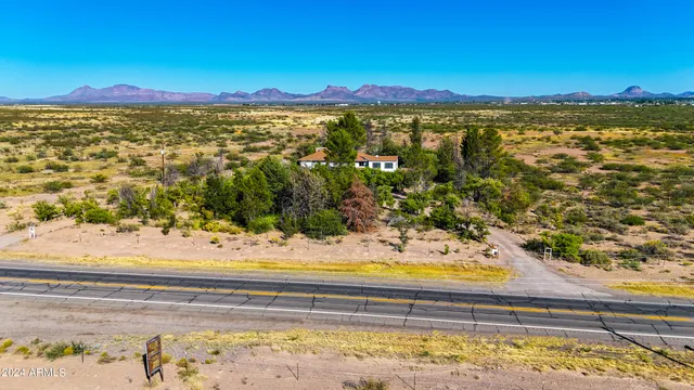 a view of a house with a yard and a trees