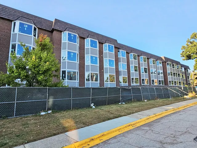 a view of wooden house with a yard