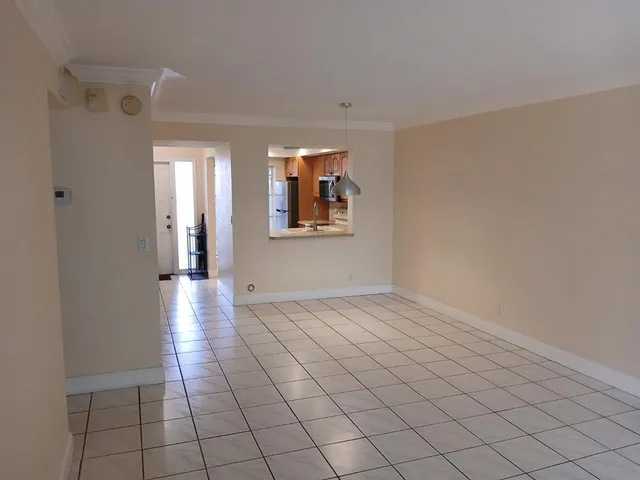 an empty room with wooden floor and a window