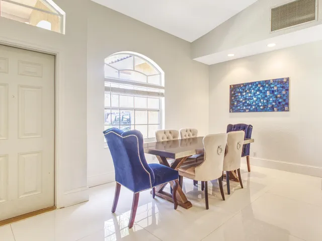 a view of a dining room with furniture and a window