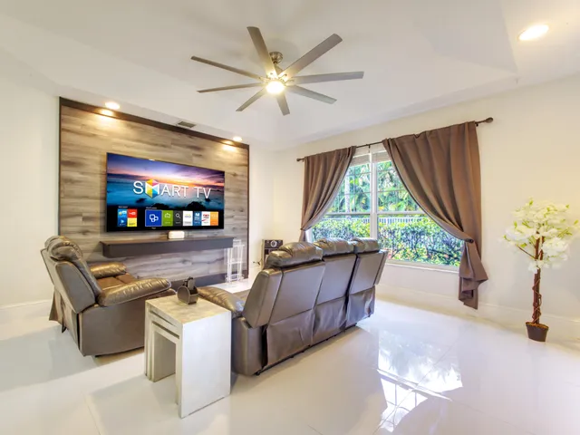 a living room with fireplace furniture and a flat screen tv