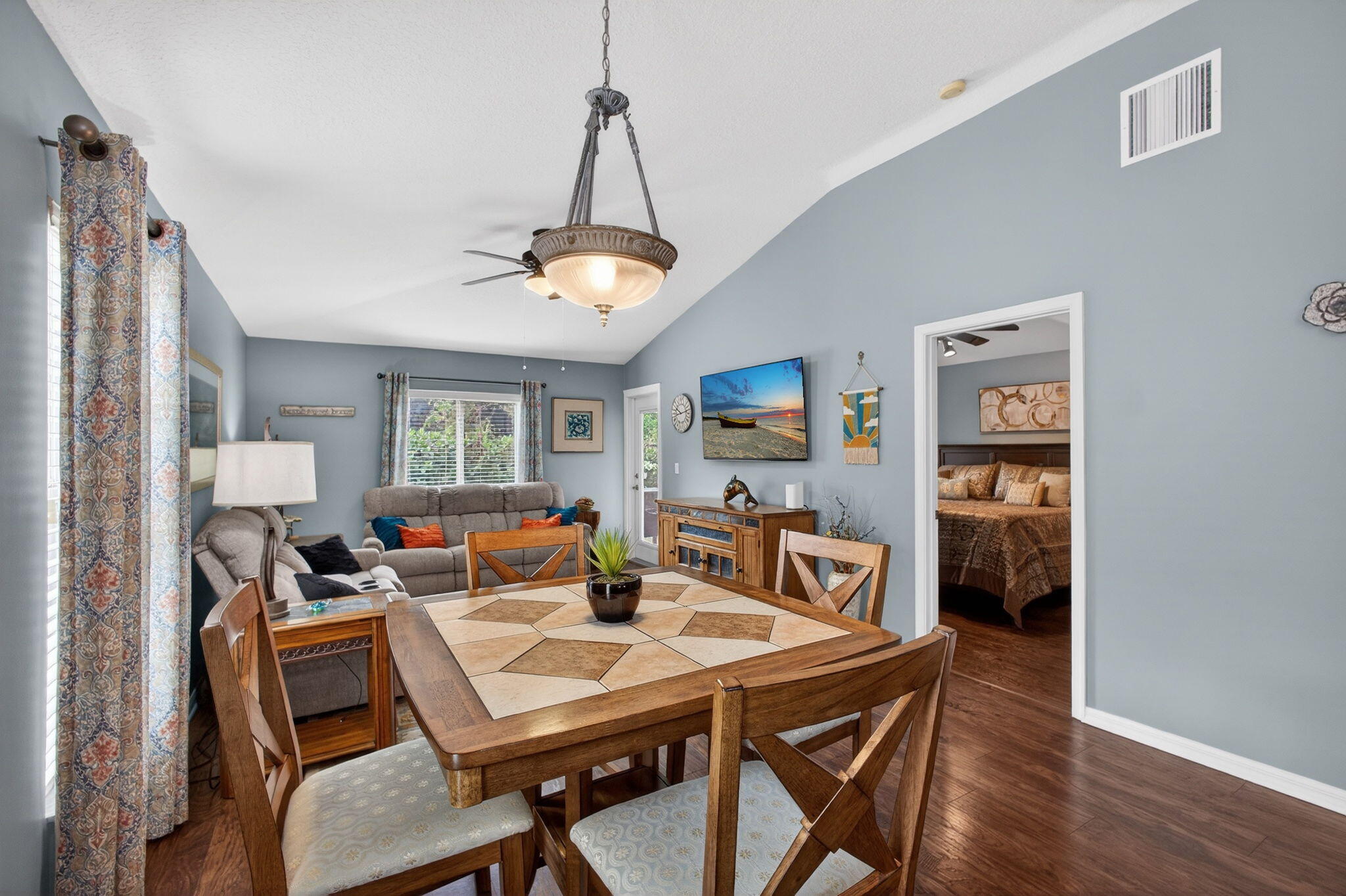 1095 Via Jardin Riviera Beach, FL 33418 - Photo 12 of 44 a view of a dining room with furniture a chandelier and wooden floor