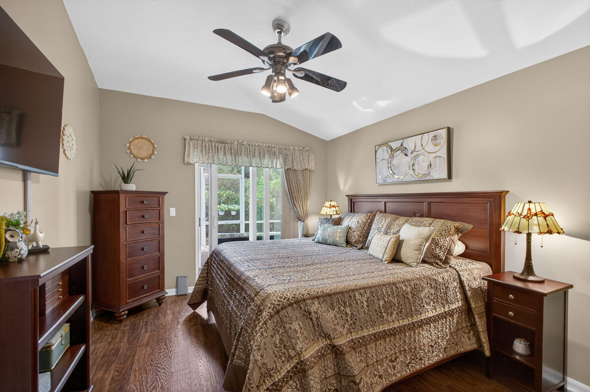 1095 Via Jardin Riviera Beach, FL 33418 - Photo 19 of 44 a bedroom with a bed dresser and a flat tv screen