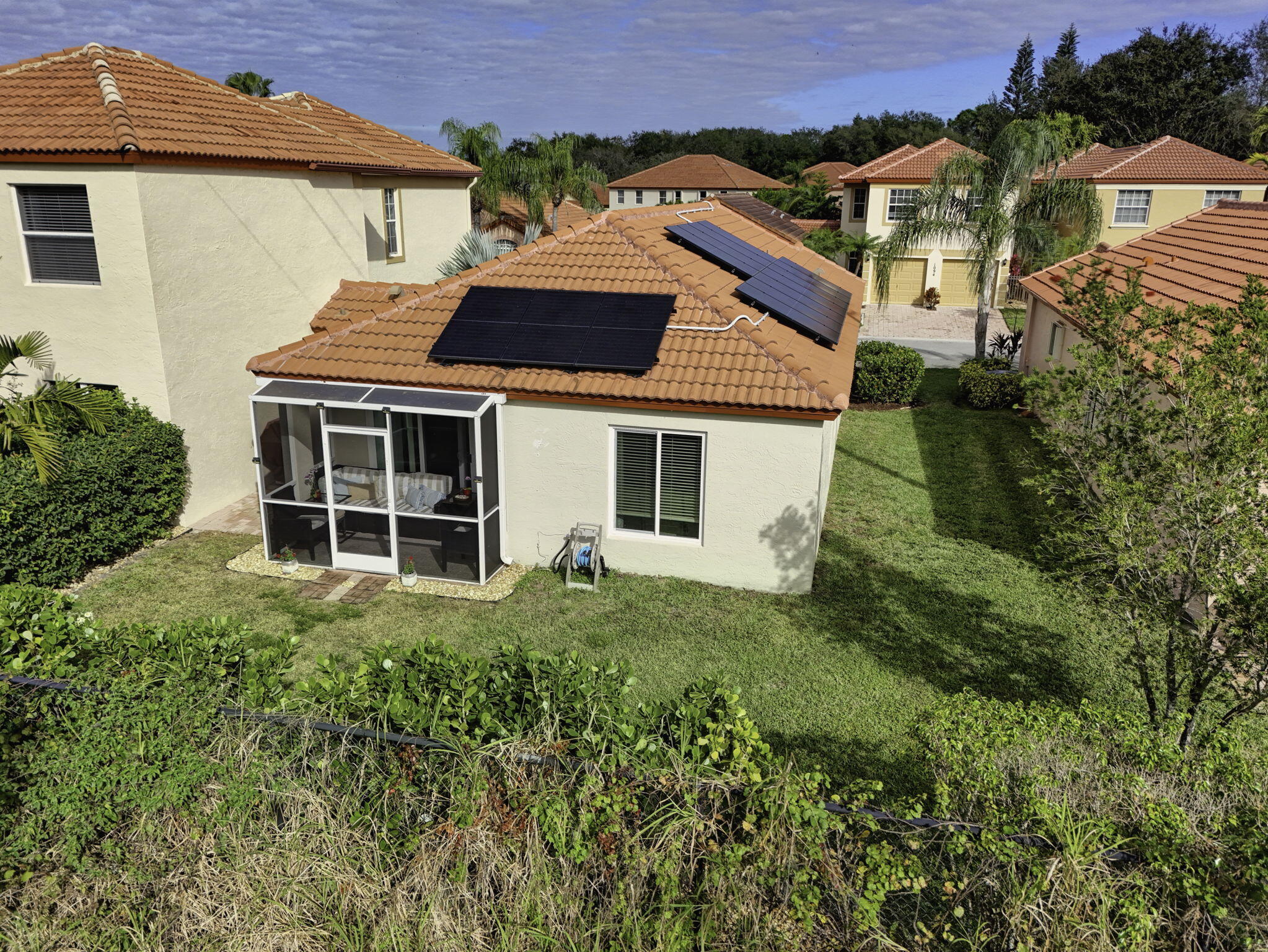 1095 Via Jardin Riviera Beach, FL 33418 - Photo 5 of 44 a front view of a house with a garden