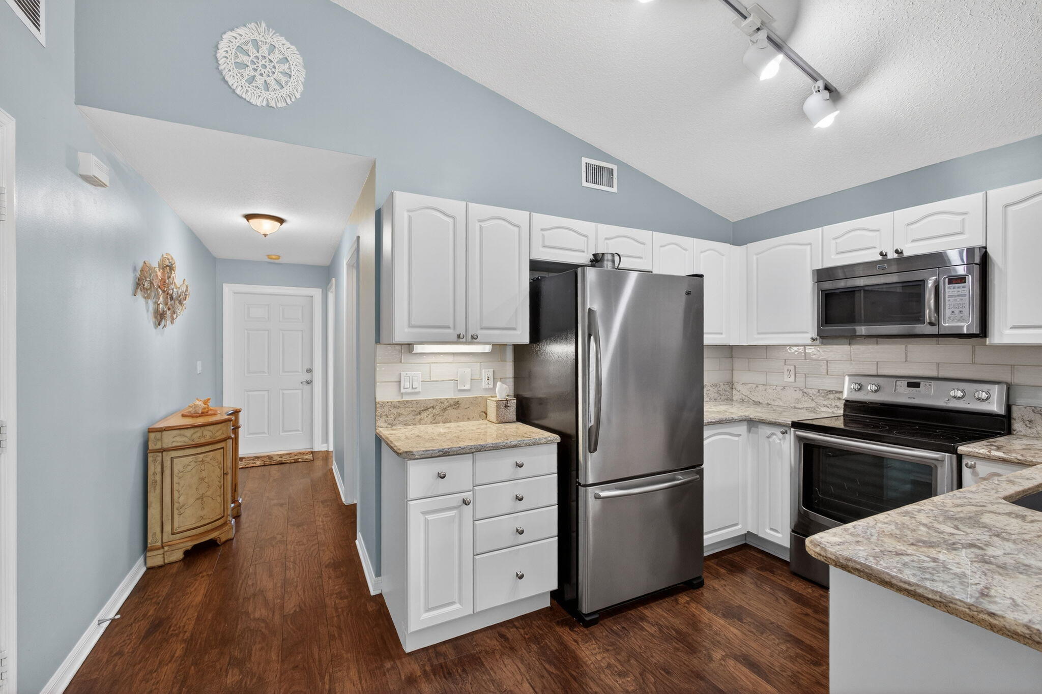 1095 Via Jardin Riviera Beach, FL 33418 - Photo 6 of 44 a kitchen with stainless steel appliances granite countertop a refrigerator stove and microwave