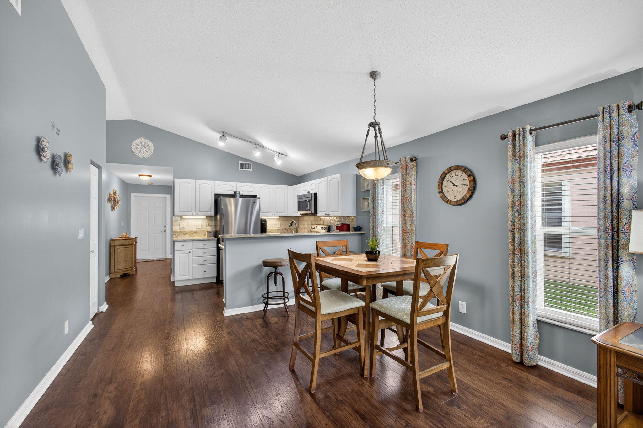 1095 Via Jardin Riviera Beach, FL 33418 - Photo 10 of 44 a view of a dining room with furniture window and wooden floor