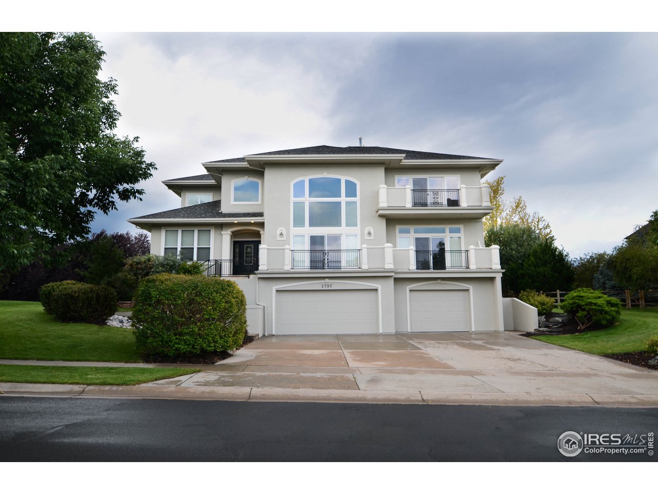 1797 Ridge W Drive Windsor, CO 80550 - Photo 1 of 33 a front view of a house with a garden