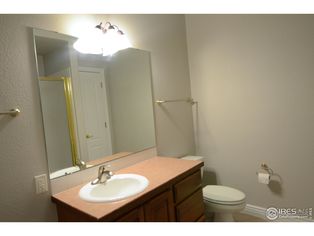 1797 Ridge W Drive Windsor, CO 80550 - Photo 30 of 33 a bathroom with a sink and a mirror